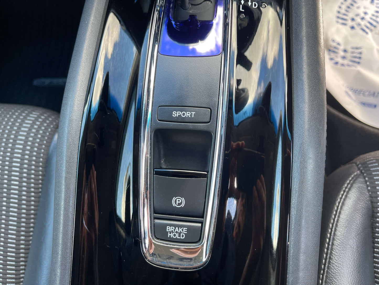 Interior controls of a 2014 Honda Vezel HR-V Hybrid SUV showing SPORT and BRAKE HOLD buttons.