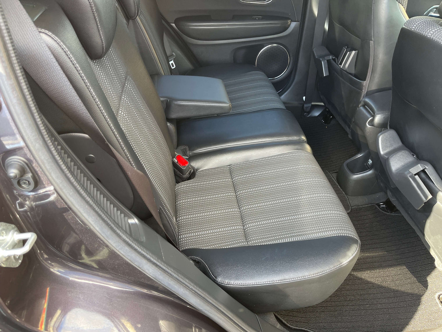 Interior view of the back seat of a 2014 Honda Vezel HR-V Hybrid Z SUV with spacious seating for five.