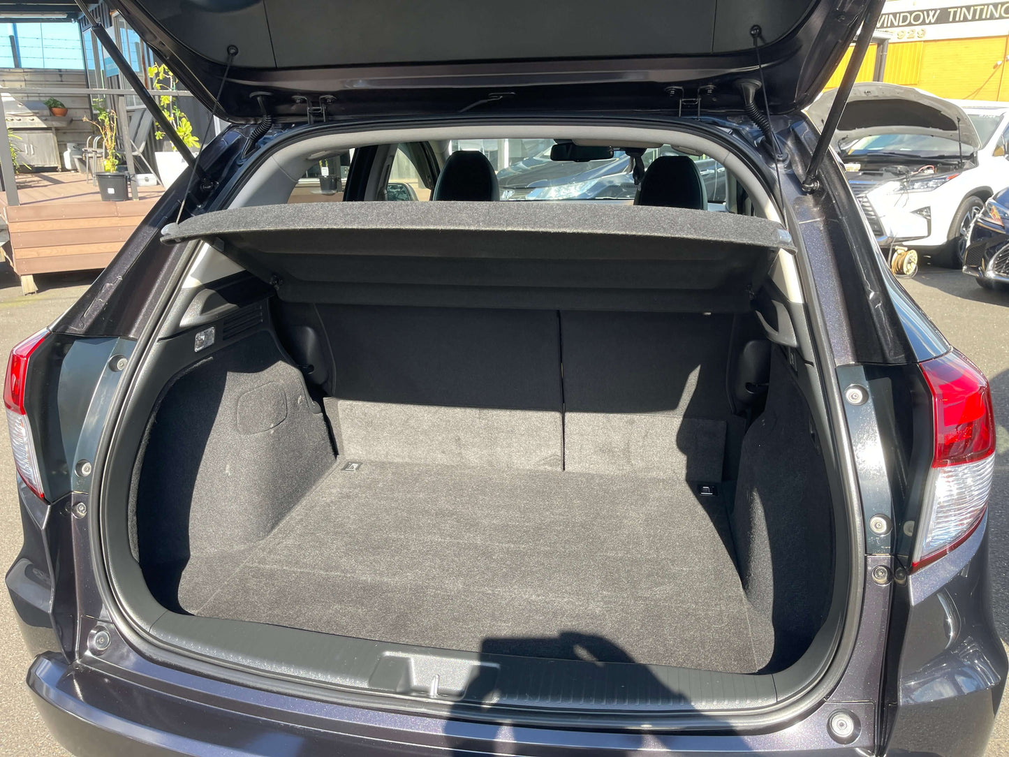 2014 Honda Vezel HR-V Hybrid SUV 5 seater trunk space view with cargo area open.