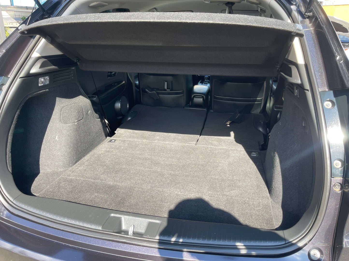 Interior view of the trunk space in a 2014 Honda Vezel HR-V Hybrid SUV showcasing ample storage area.