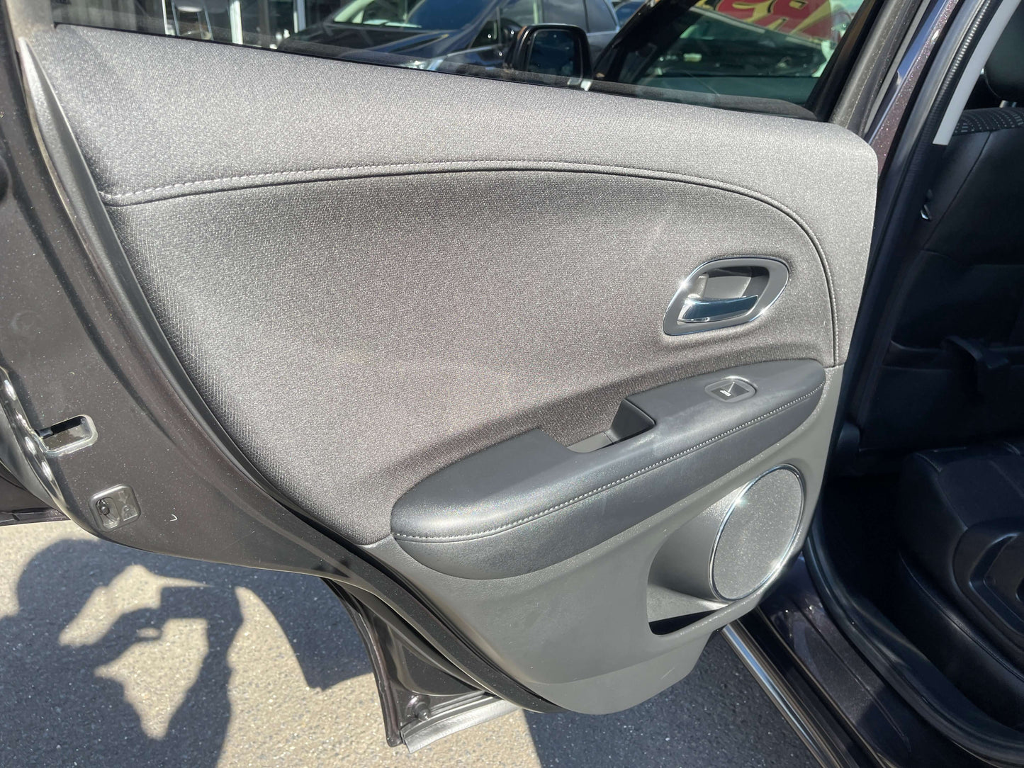 Interior door panel of a 2014 Honda Vezel HR-V Hybrid Z SUV, showcasing modern design and features.