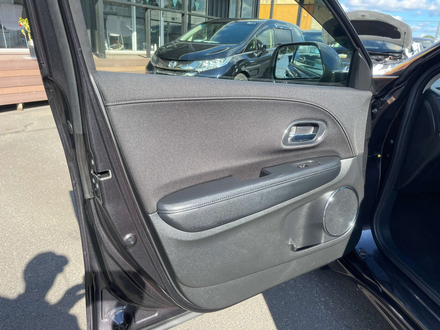 Interior view of the 2014 Honda Vezel HR-V Hybrid Z SUV door with sleek design and features.