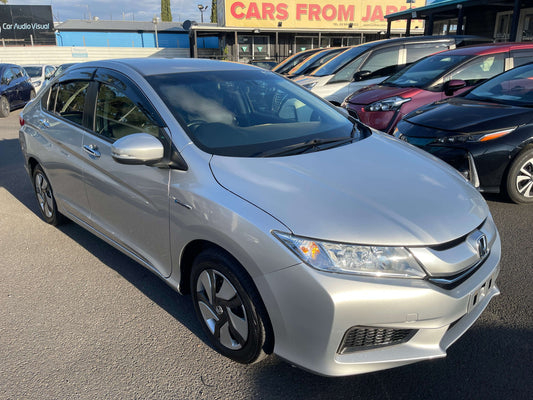 2016 Honda Grace 1.5 Hybrid LX Sedan 5 seater parked in a car lot, showcasing its sleek silver design.