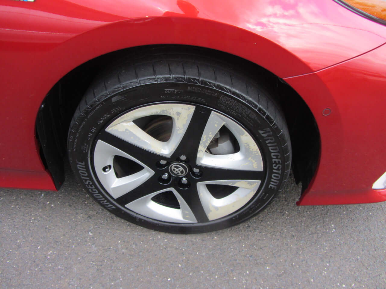Close-up of the wheel of a 2019 Toyota Prius Prime Plug-In Hybrid 1.8L, showcasing the black and silver alloy rim.