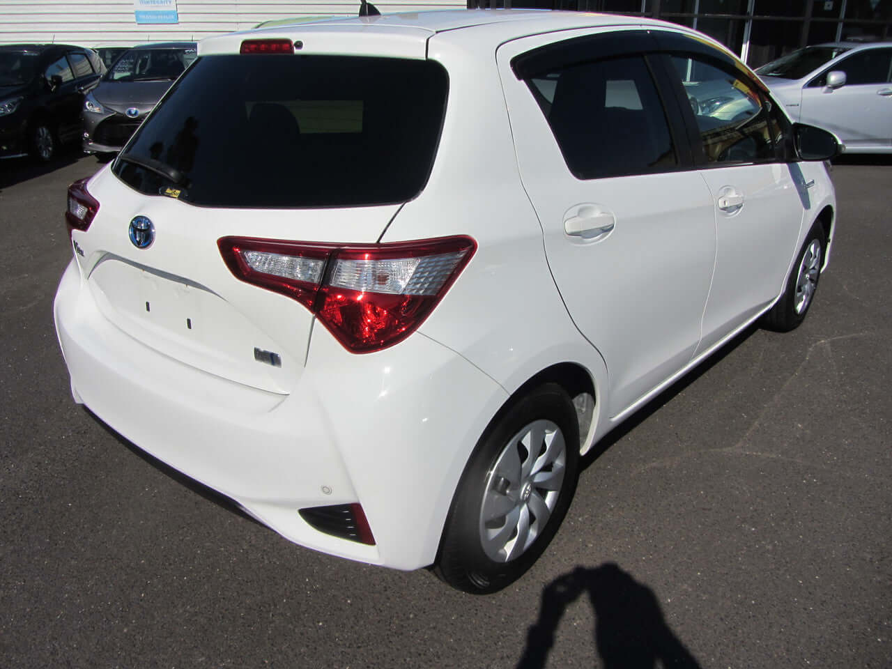 2018 Toyota Vitz 1.5L Hybrid rear view showcasing sleek design and white color.