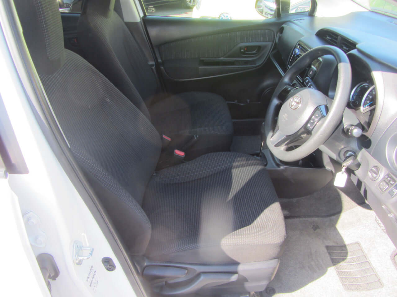 Interior view of 2018 Toyota Vitz 1.5L Hybrid showing driver's side seating and dashboard area.