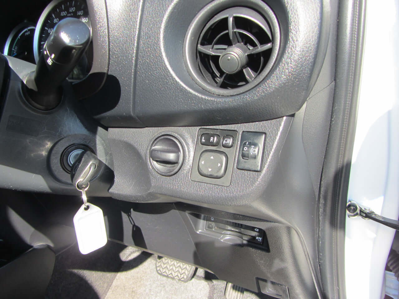 Interior view of 2018 Toyota Vitz 1.5L Hybrid showing control panel and air vents.