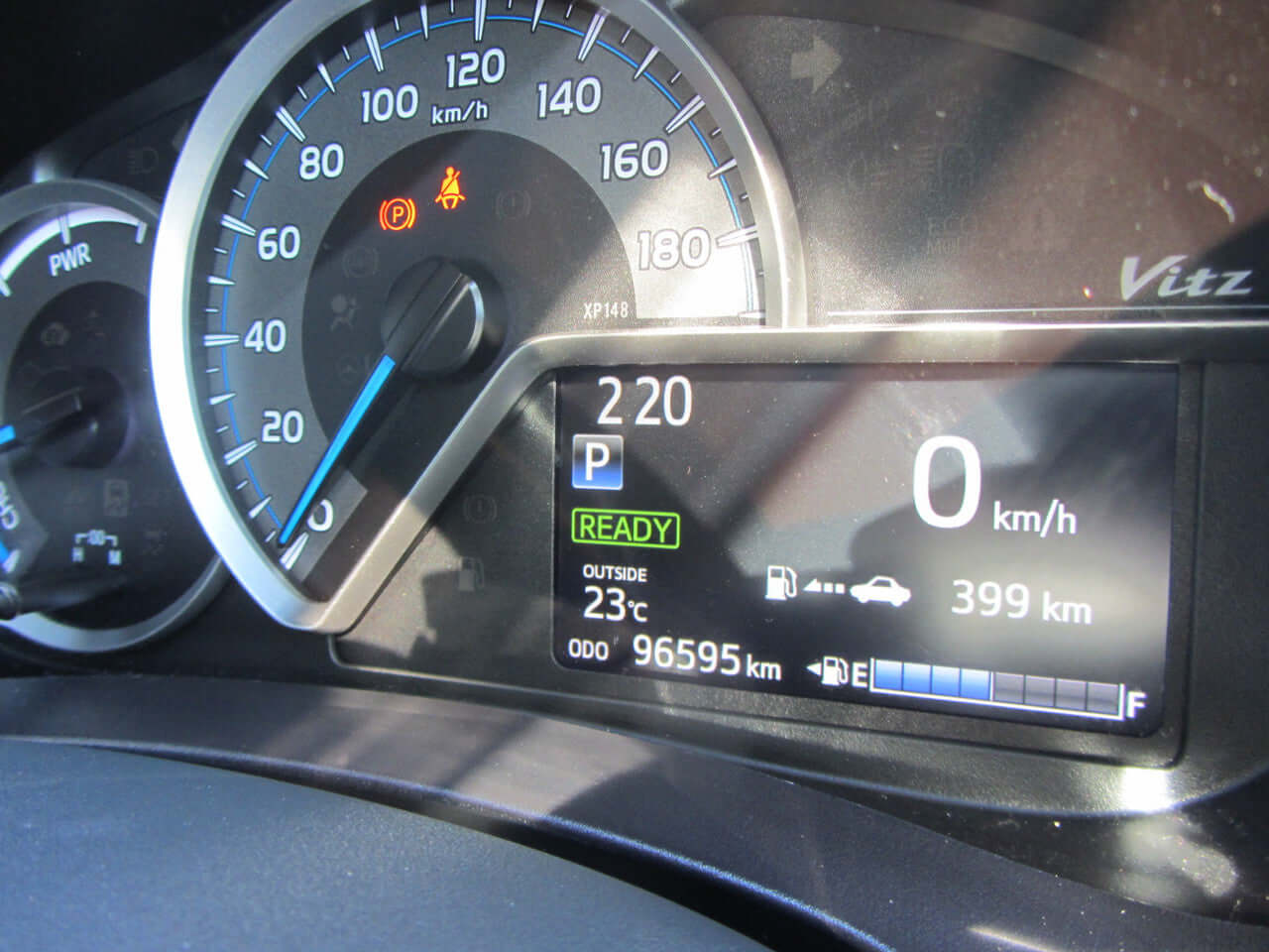 Dashboard display of a 2018 Toyota Vitz 1.5L Hybrid showing speed and mileage of 96595 km.