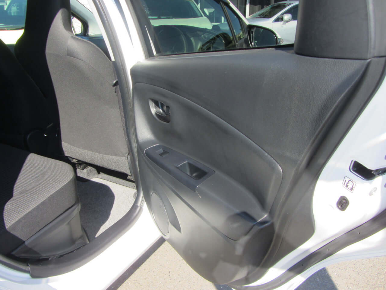 Interior view of the 2018 Toyota Vitz 1.5L Hybrid, showcasing the rear door panel and seating.