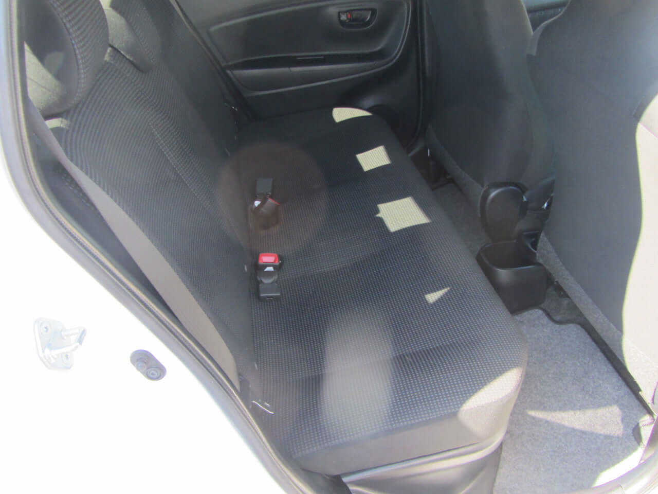 Backseat interior of a 2018 Toyota Vitz 1.5L Hybrid, showcasing spacious and comfortable seating.