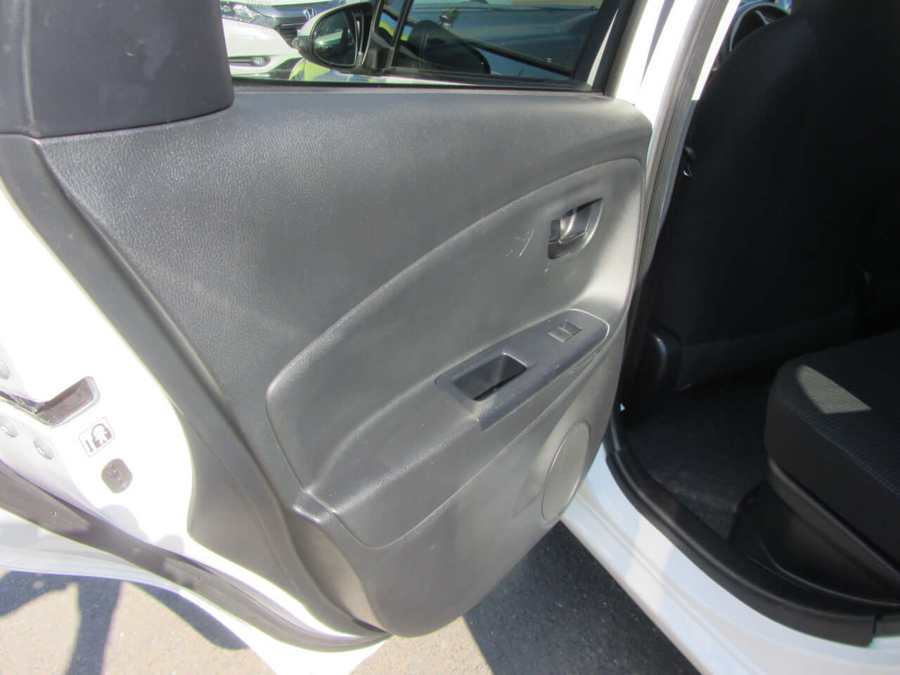 Interior door panel of 2018 Toyota Vitz 1.5L Hybrid, showcasing design and materials.