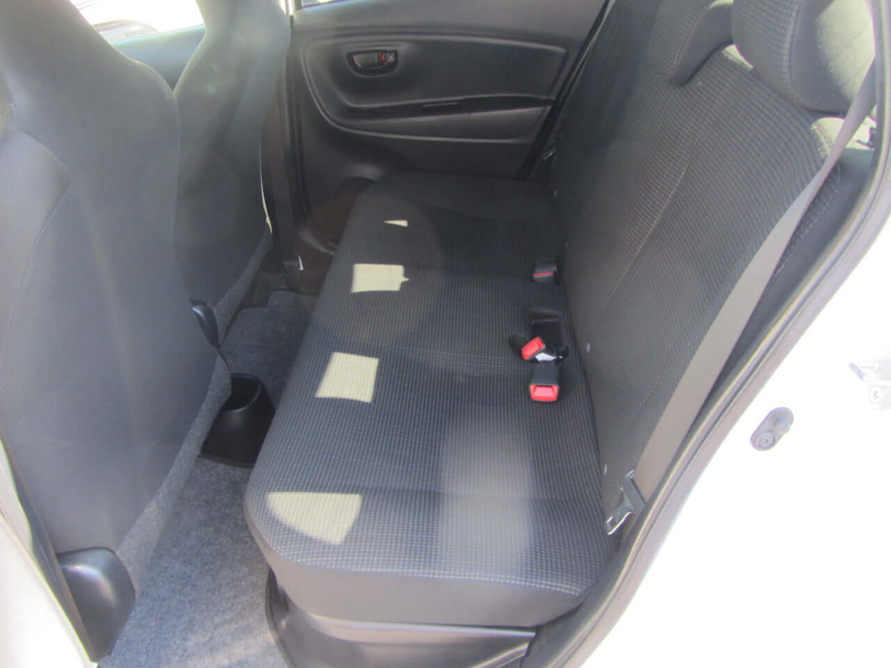 Back seat interior of 2018 Toyota Vitz 1.5L Hybrid showing spacious seating and upholstery details.