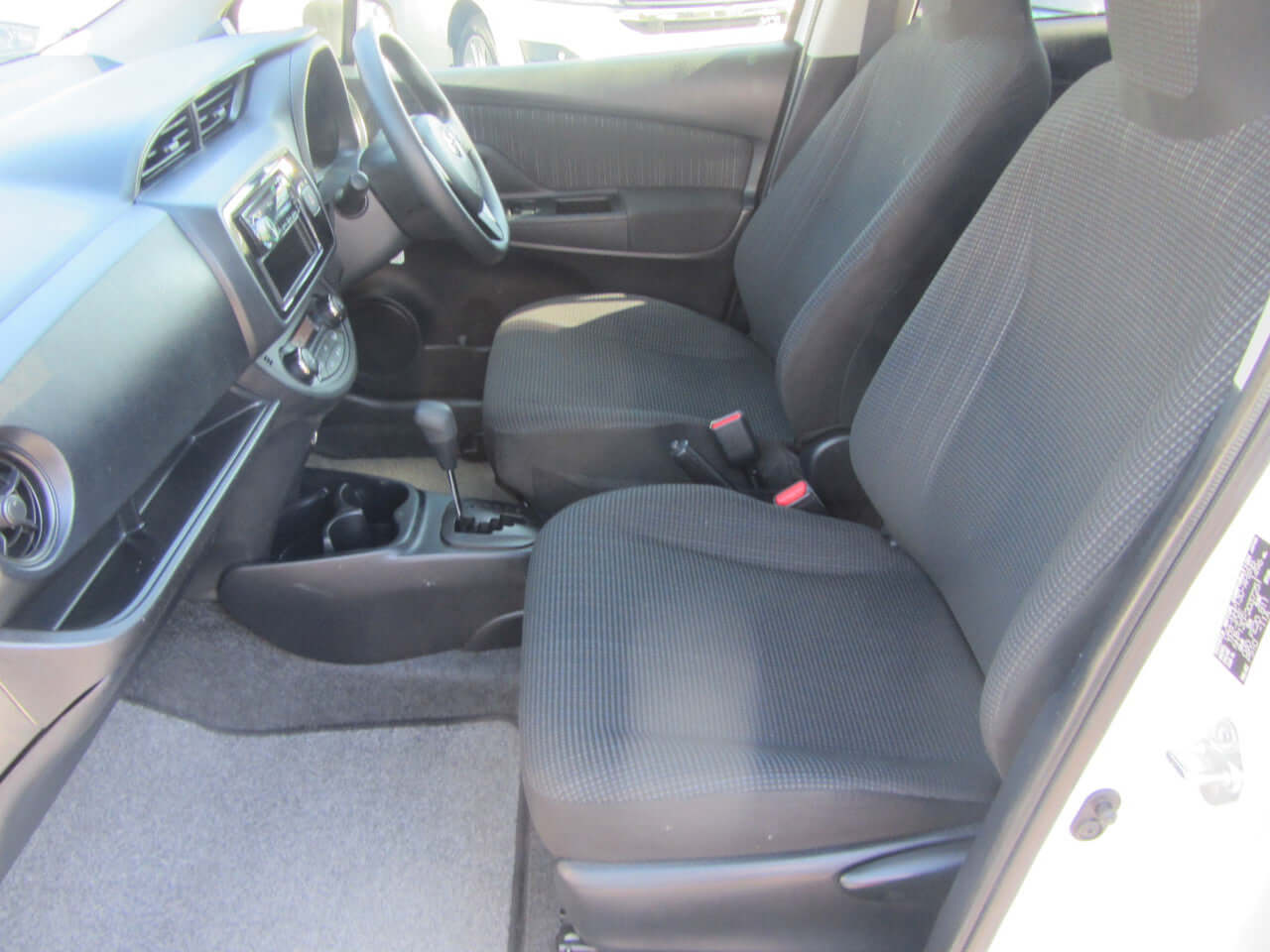Interior view of 2018 Toyota Vitz 1.5L Hybrid, featuring comfortable front seats and modern dashboard.