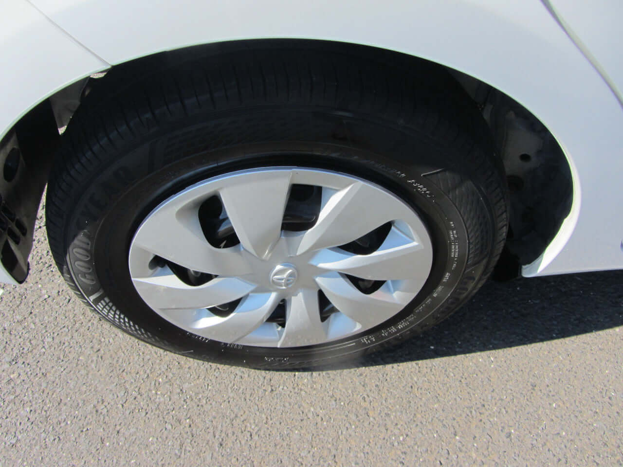 Close-up view of the alloy wheel and tire of a 2018 Toyota Vitz 1.5L Hybrid, showcasing its design and tread.