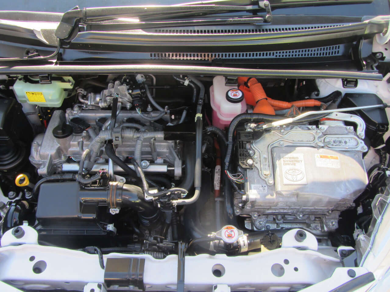 2018 Toyota Vitz 1.5L Hybrid engine compartment, showcasing hybrid technology with efficient design and components.