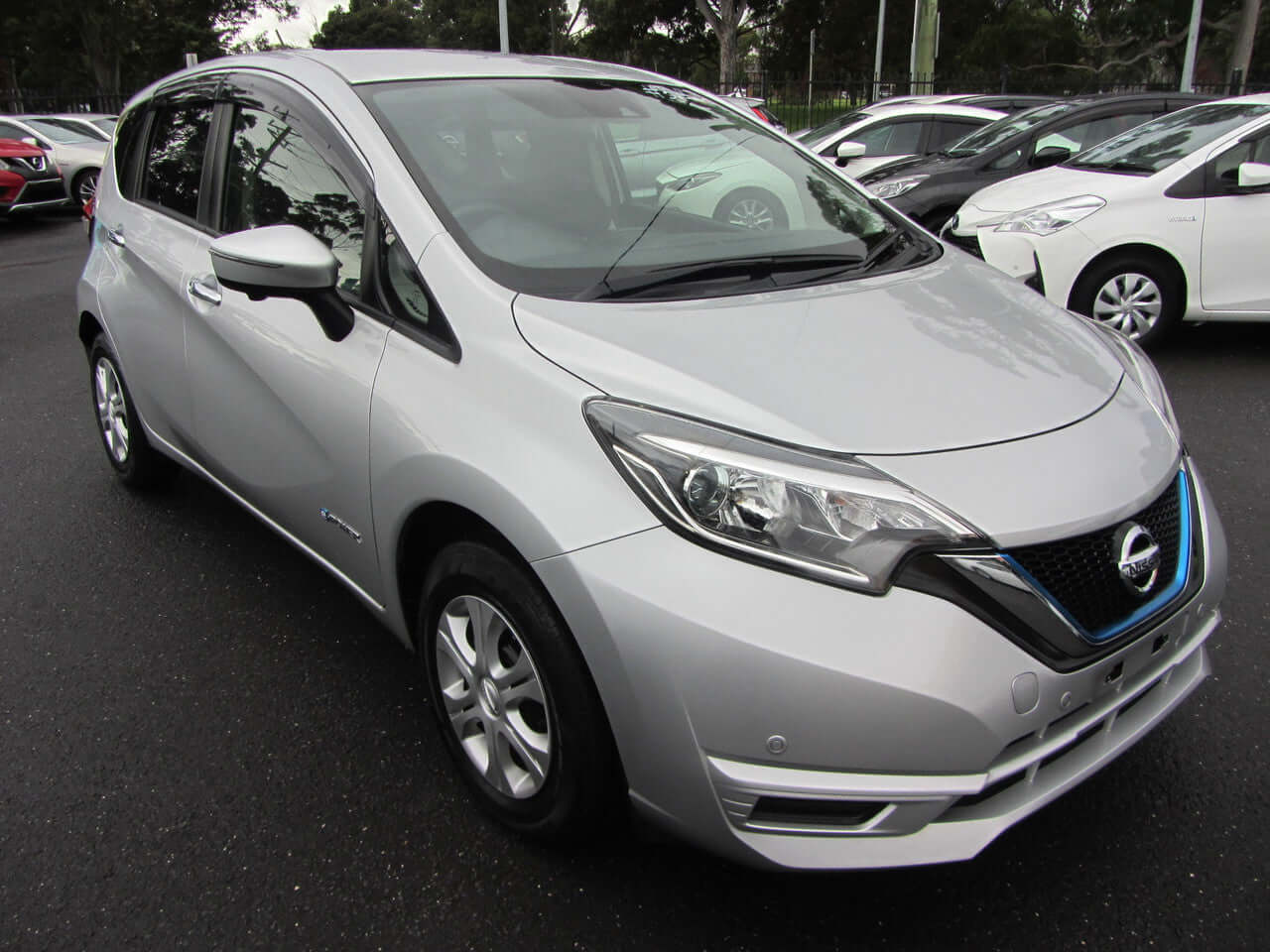 2019 Nissan Note e-Power G Edition, silver hybrid car parked in a dealership lot.