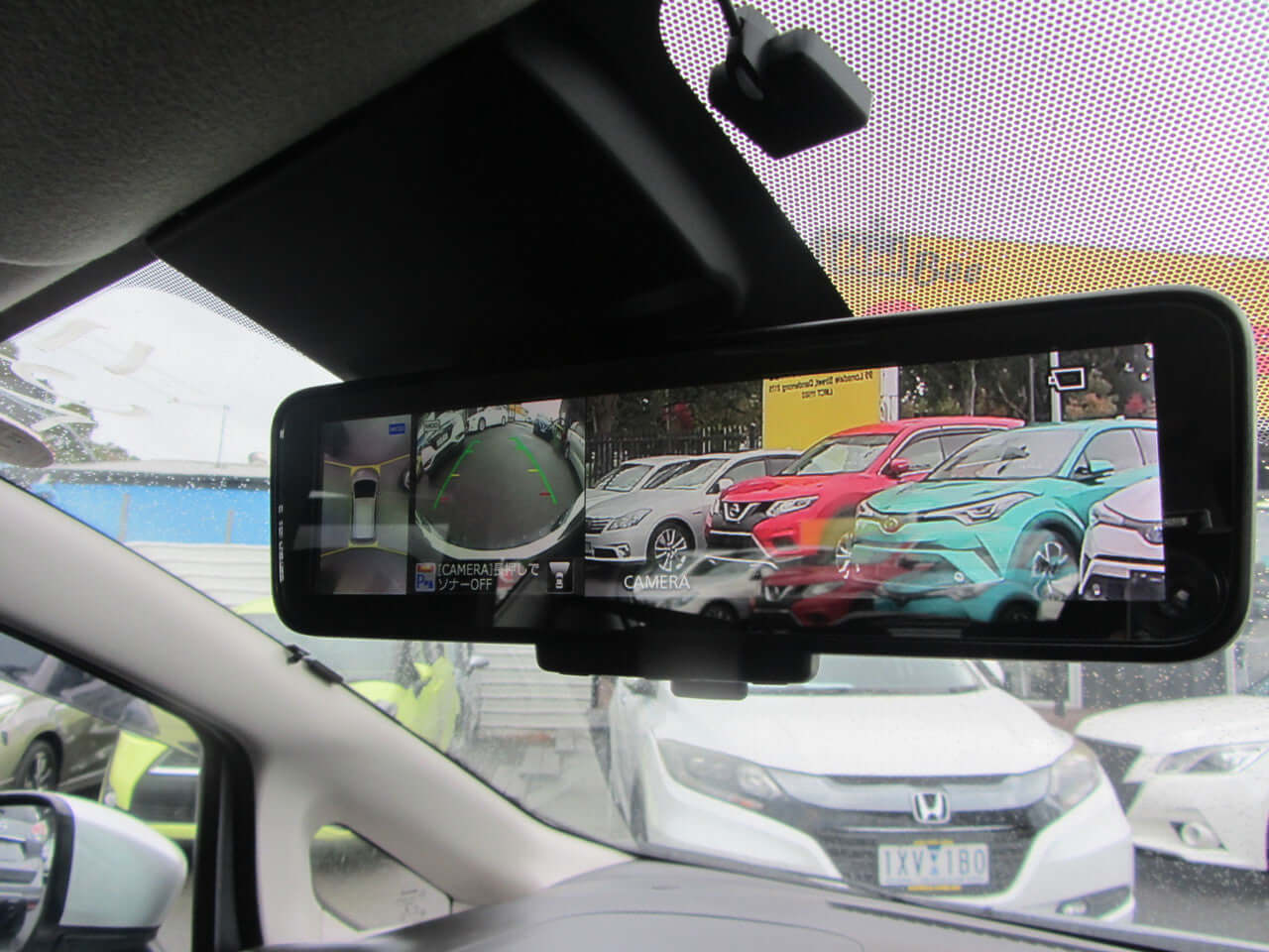 Rearview mirror display showing 2019 Nissan Note e-Power and other cars in the background.