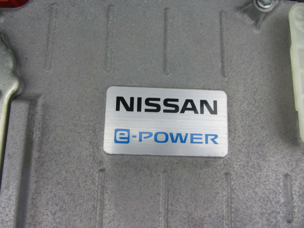 2019 Nissan Note e-Power Nissan e-Power logo on vehicle component, representing the innovative hybrid technology features.