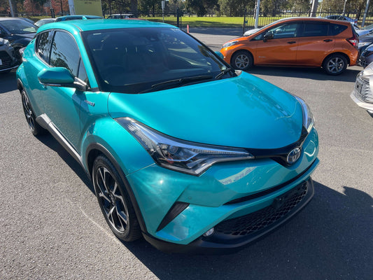 2017 Toyota C-HR 1.8L Hybrid Full Option Luxury SUV in vibrant turquoise color parked outdoors.