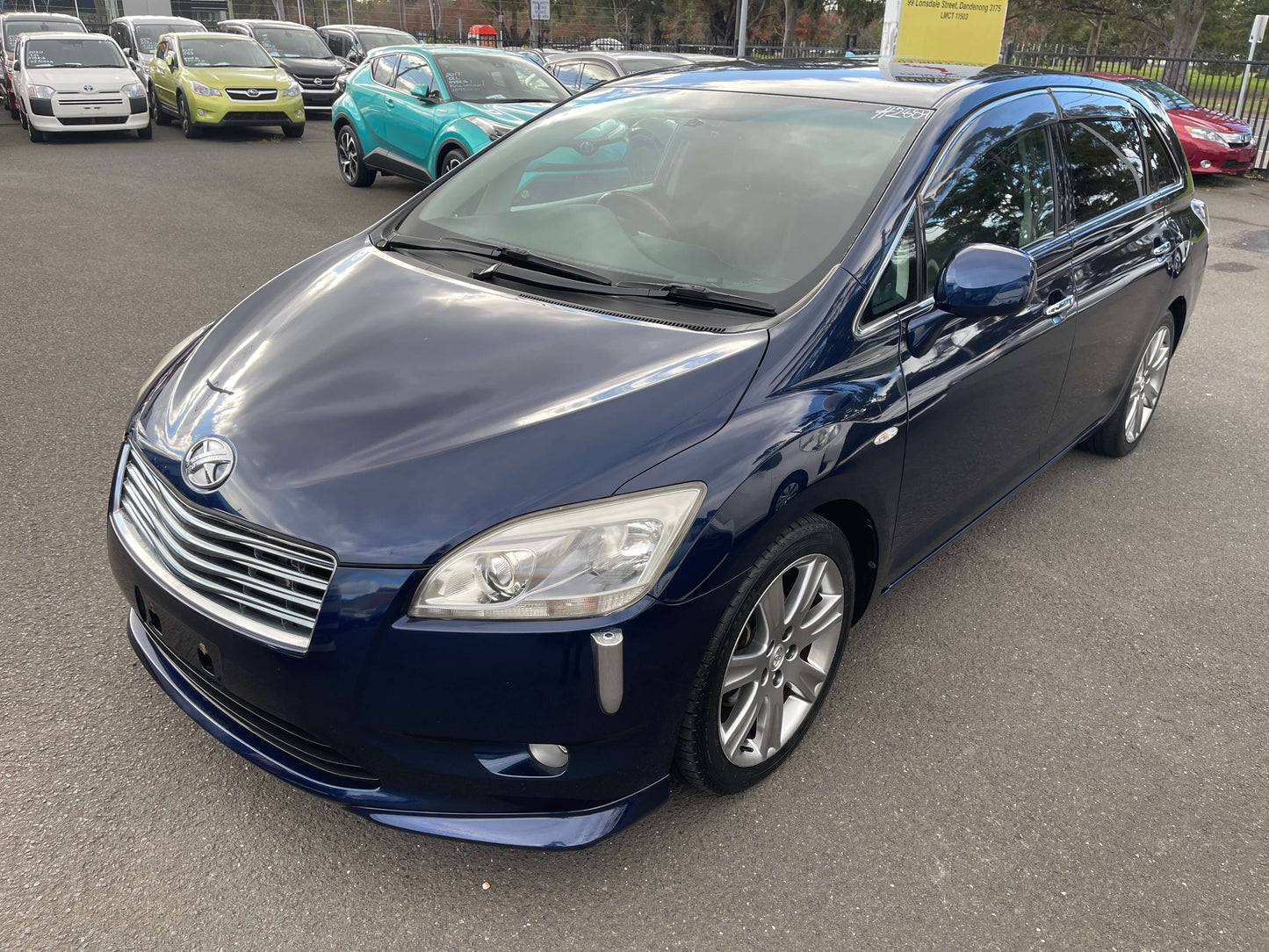 2008 Toyota Mark X Zio V6 3.5L 350G 6 seats, blue wagon parked with other cars in background.