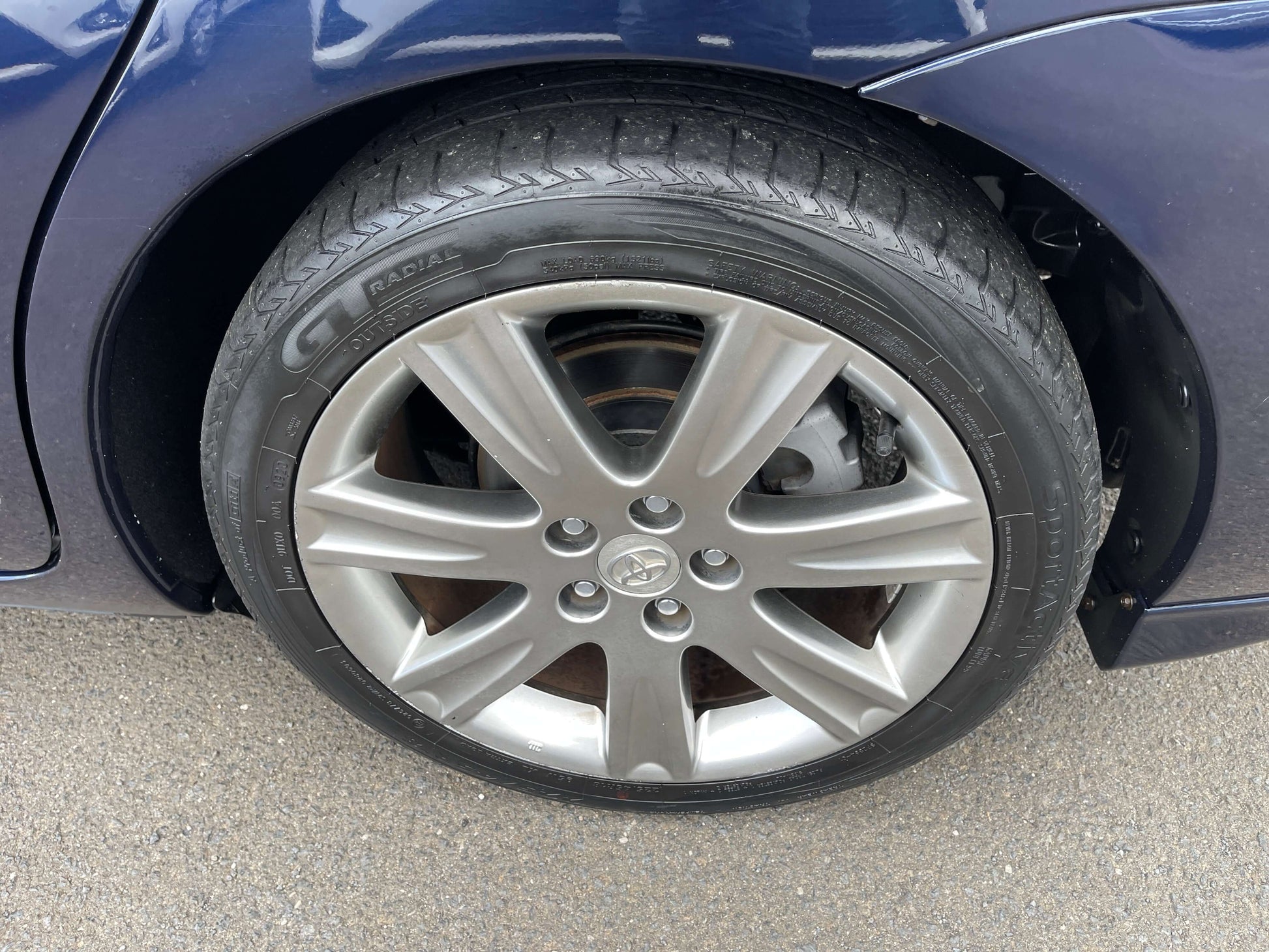 2008 Toyota Mark X Zio V6 3.5L alloy wheel and tire close-up, showcasing 6-spoke design and tread pattern.