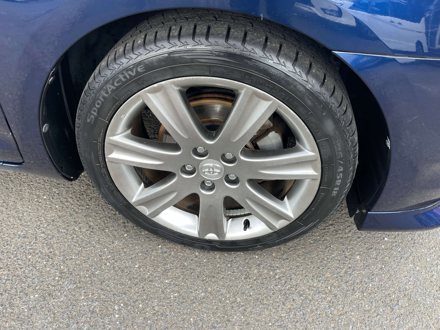 2008 Toyota Mark X Zio V6 3.5L alloy wheel with tire on blue vehicle close-up