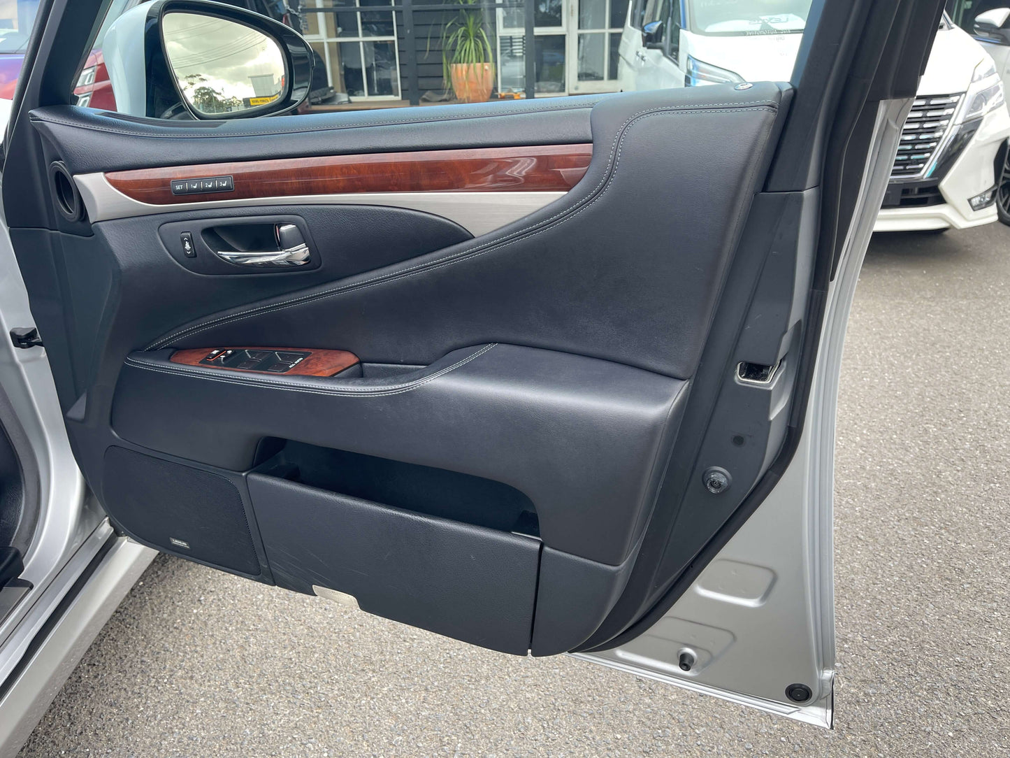 Interior view of the 2015 Lexus LS460 AWD V8 4.6L door showing luxury features and wood accents.