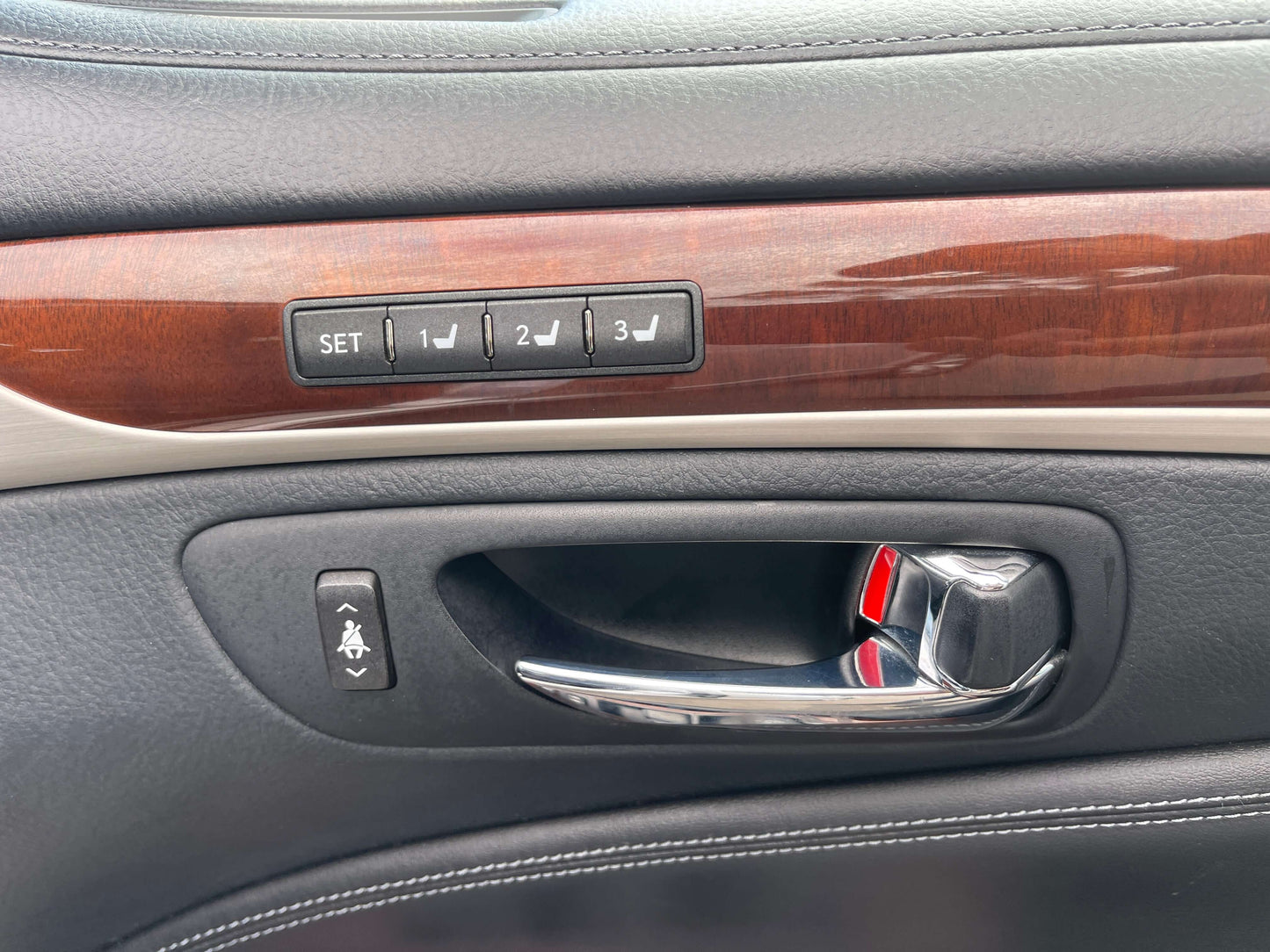 Interior details of a 2015 Lexus LS460 AWD V8 4.6L showing door controls and memory seat buttons.