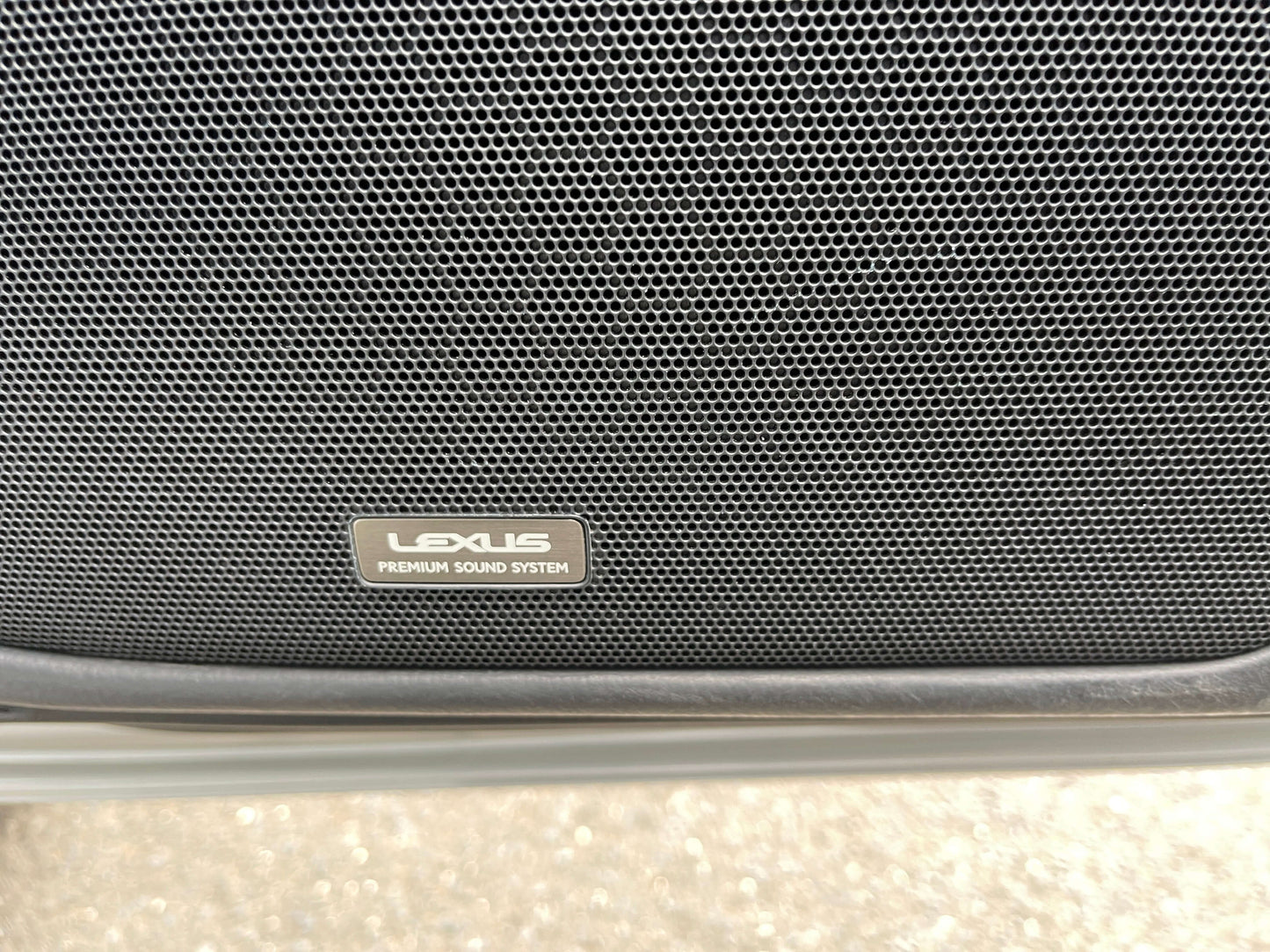 2015 Lexus LS460 AWD V8 4.6L Close-up of Lexus Premium Sound System speaker grille in a luxury sedan.