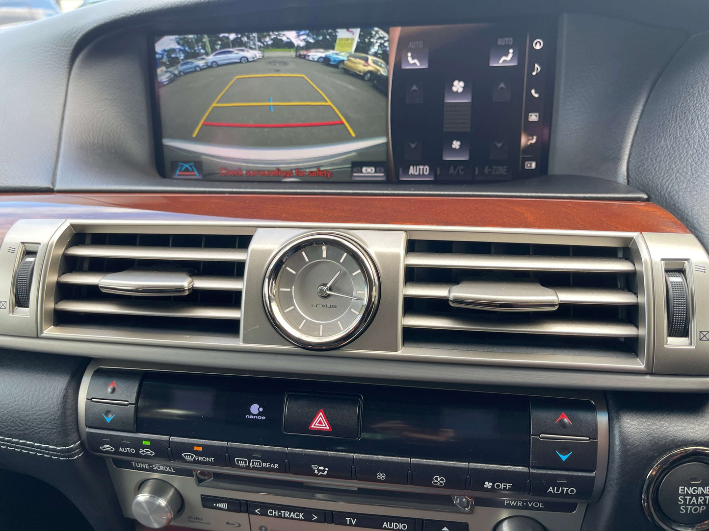 Interior view of 2015 Lexus LS460 AWD V8 4.6L with navigation, climate controls, and rearview camera display.