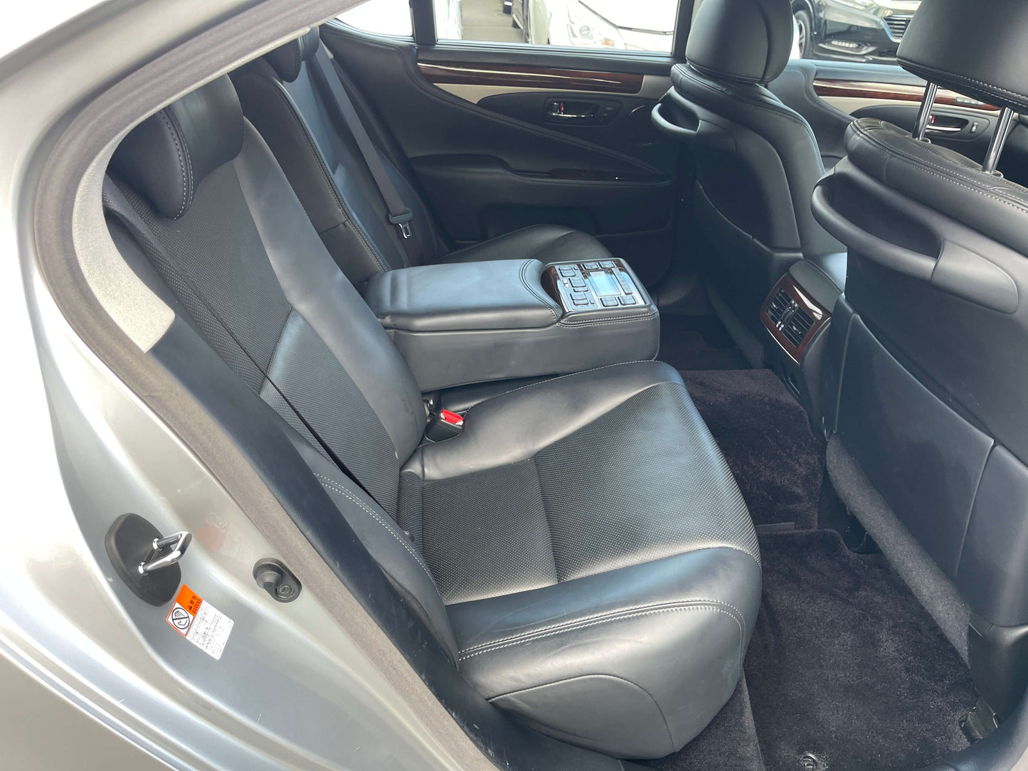 Interior view of the backseat of a 2015 Lexus LS460 AWD V8 4.6L showing luxury leather seating and spacious design.