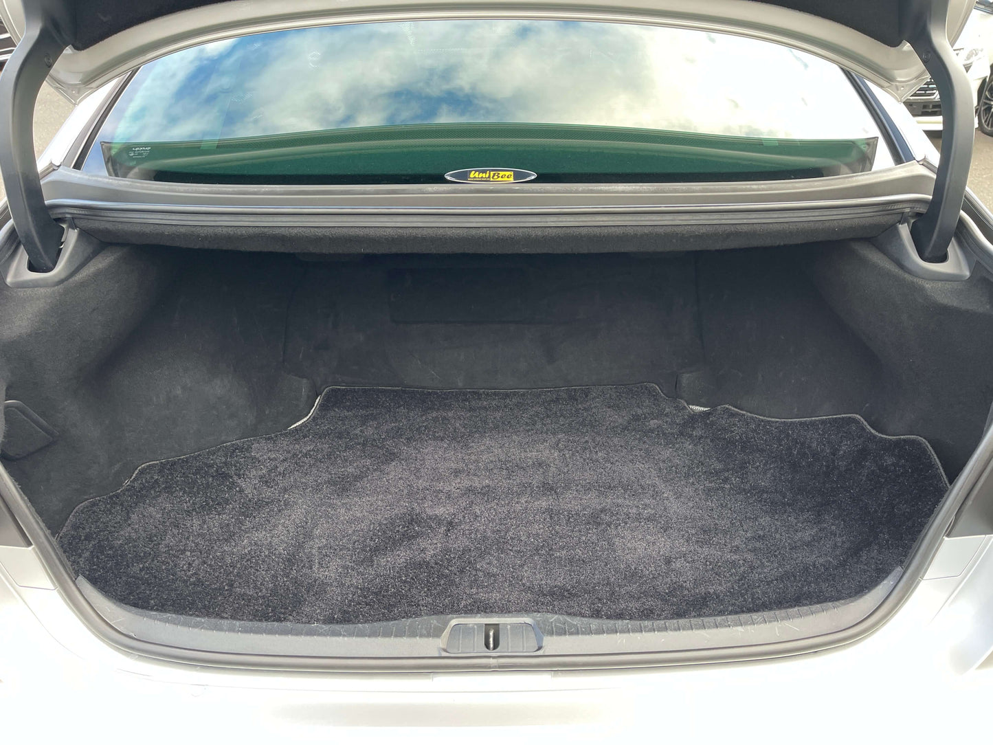 Trunk space of a 2015 Lexus LS460 AWD V8 4.6L, featuring a clean and spacious interior for storage.