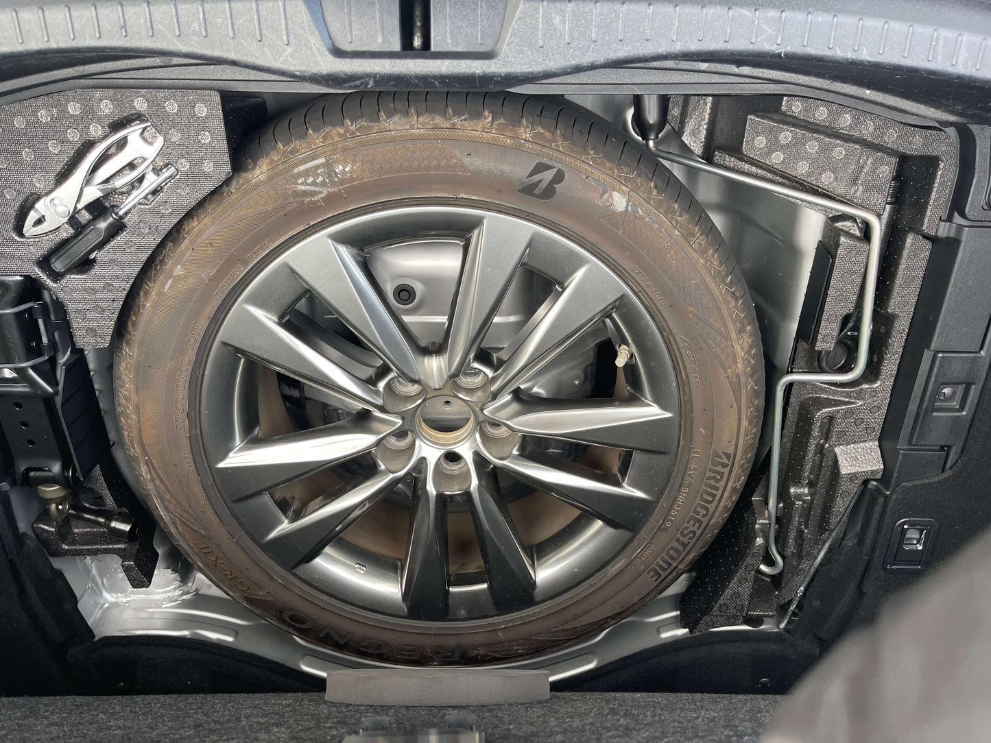 Spare tire located in the trunk of a 2015 Lexus LS460 AWD V8 4.6L Premium Luxury Sedan.