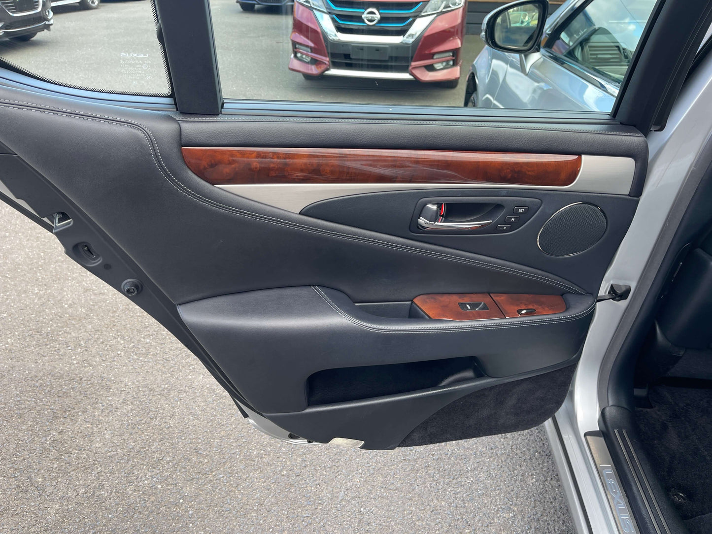 Interior view of the 2015 Lexus LS460 AWD V8 4.6L door panel showcasing premium materials and design.