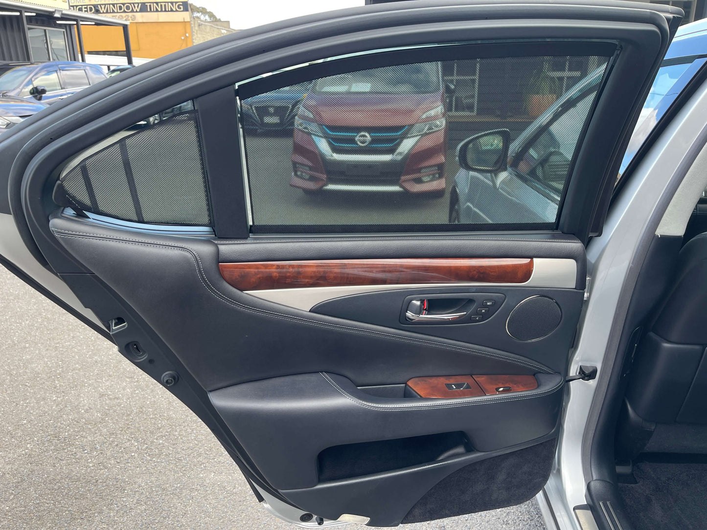 Interior view of the 2015 Lexus LS460 AWD V8 4.6L Version L luxury sedan's rear door panel.