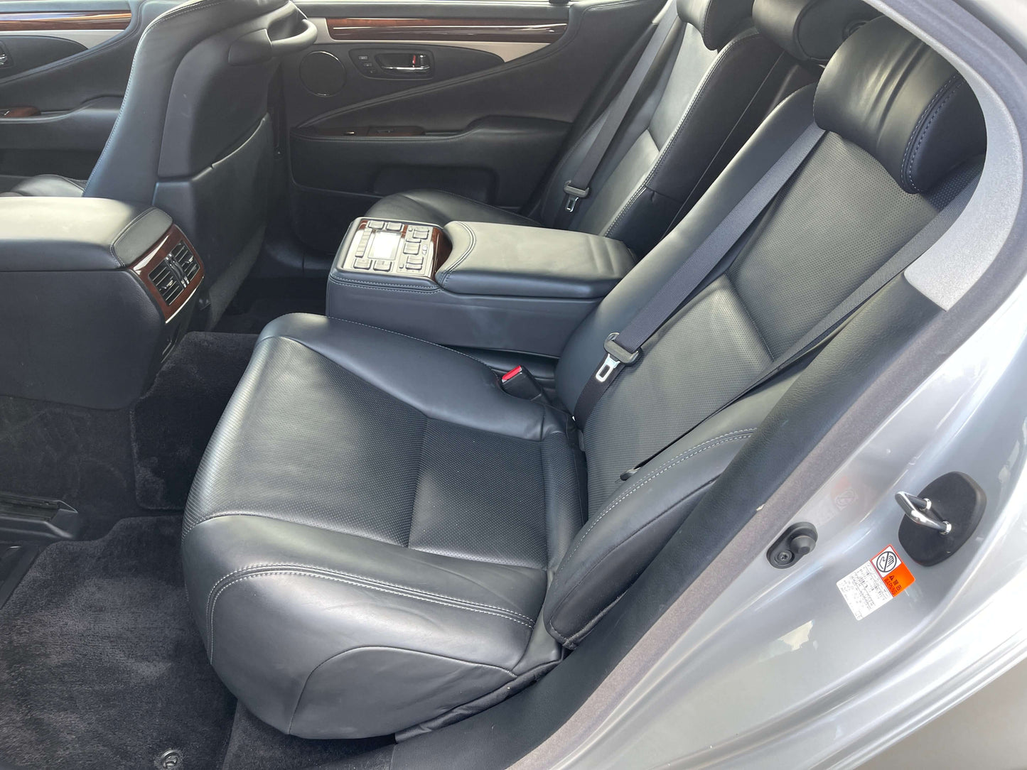 Interior view of the 2015 Lexus LS460 AWD V8 4.6L featuring plush leather seats and spacious rear seating arrangement.