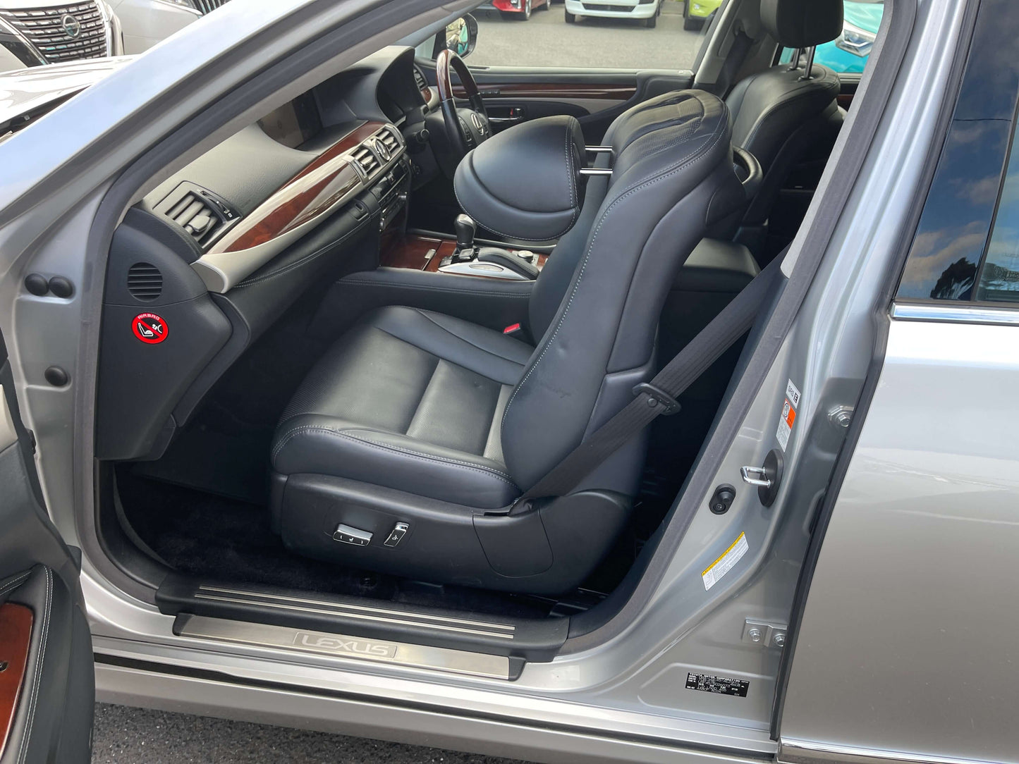 Interior view of 2015 Lexus LS460 AWD V8 4.6L showing premium leather seating and dashboard features.