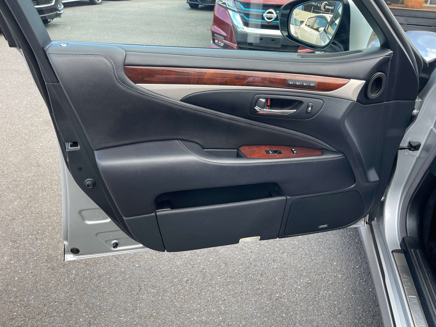 Interior view of the 2015 Lexus LS460 AWD V8 4.6L showing the luxurious door panel design.