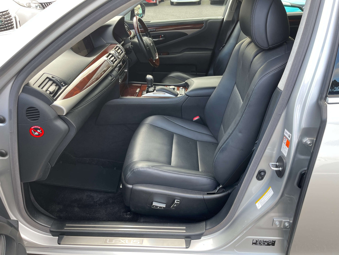 Interior view of 2015 Lexus LS460 AWD V8 4.6L showing black leather seats and luxurious cabin features.