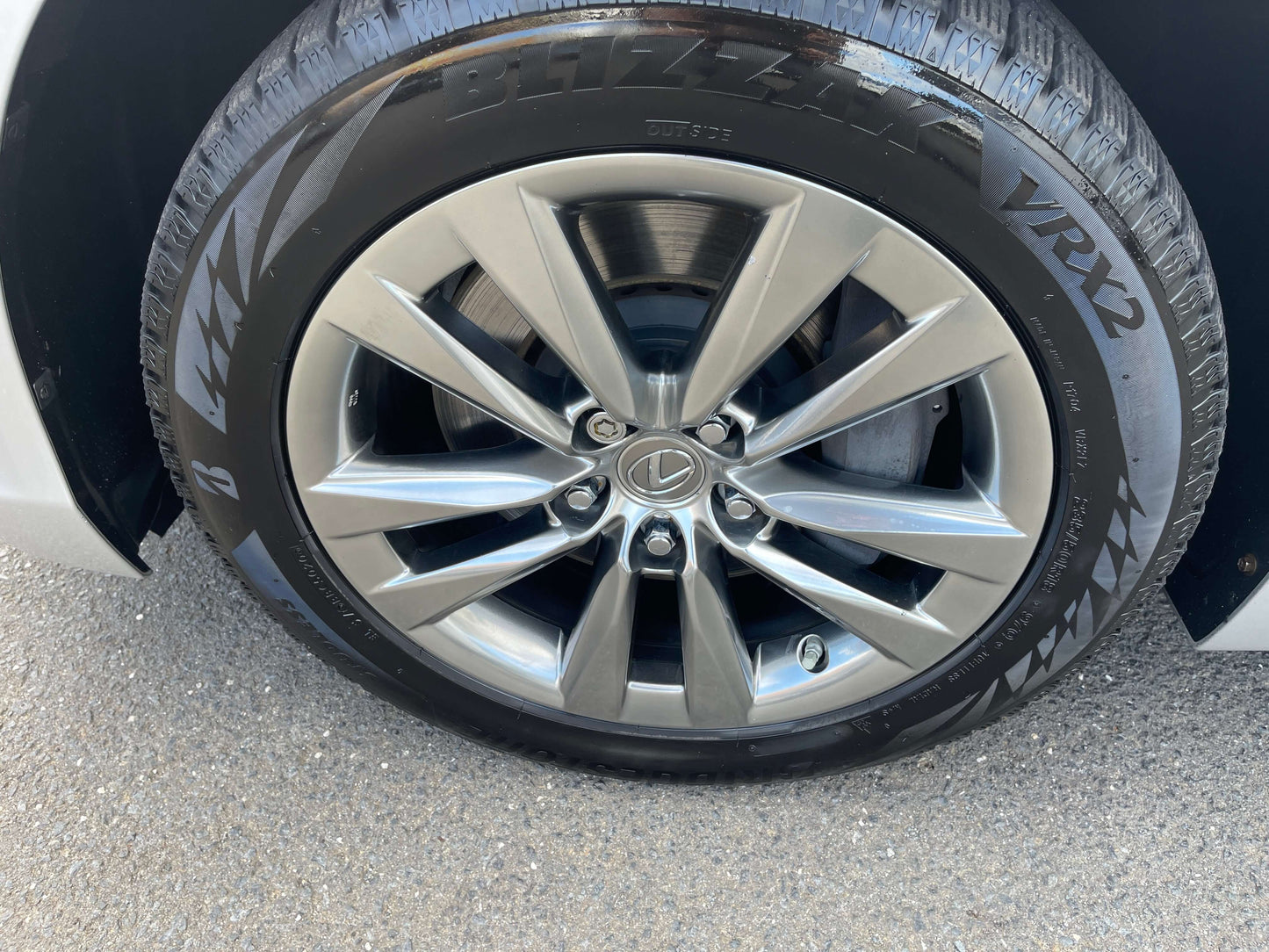 Close-up of a 2015 Lexus LS460 AWD V8 4.6L luxury sedan wheel with alloy rims and tire tread detail.