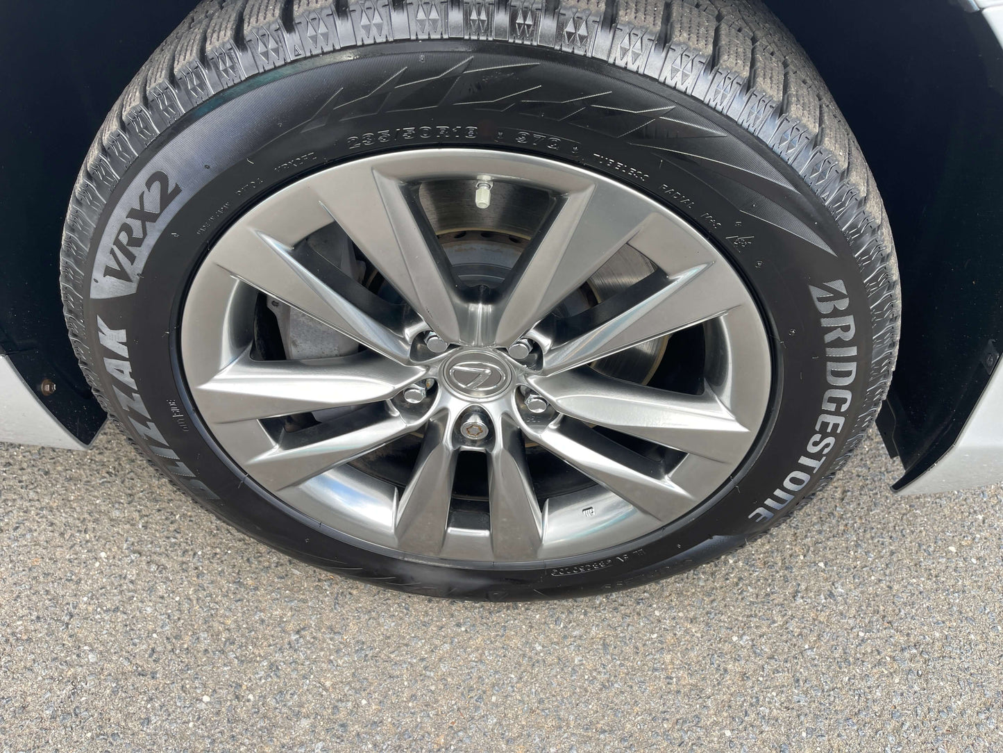 Close-up of a 2015 Lexus LS460 AWD V8 4.6L luxury sedan wheel with Bridgestone tires.