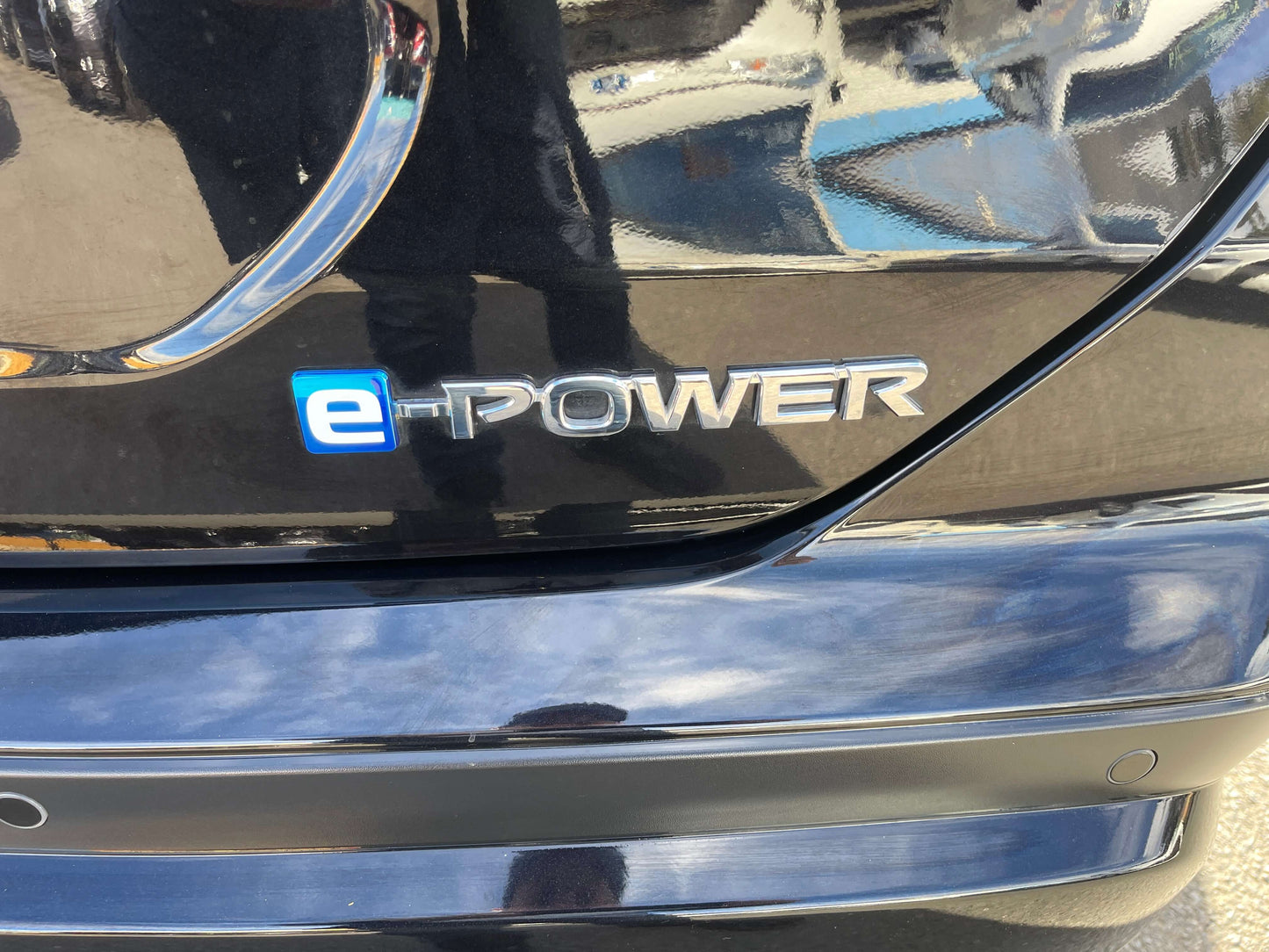 2020 Nissan Kicks e-Power X Edition logo showcasing e-Power branding on a sleek black vehicle.