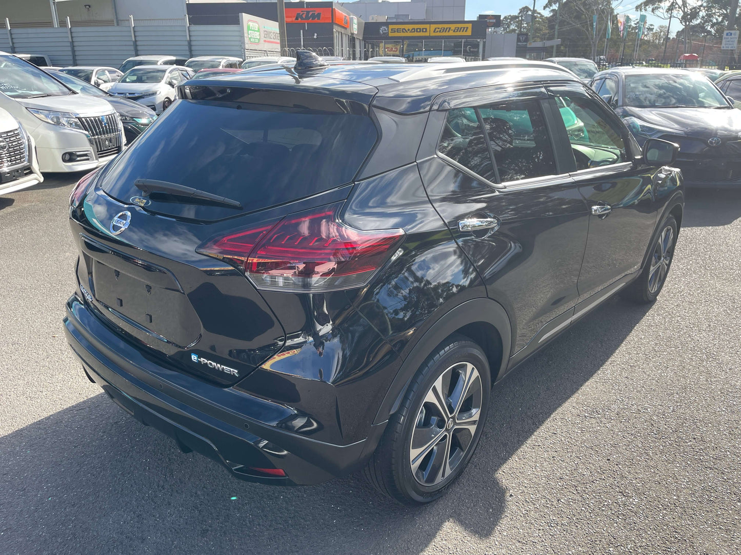 2020 Nissan Kicks e-Power X Edition black SUV rear view in a parking lot with other vehicles