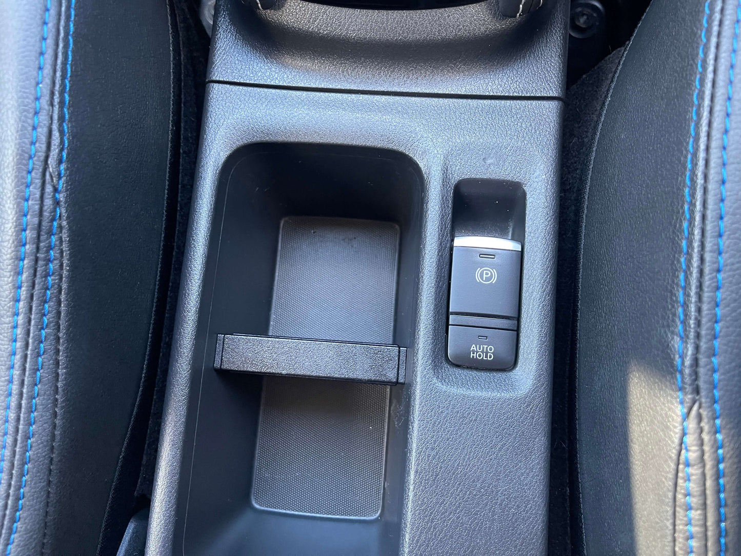 Center console of the 2020 Nissan Kicks e-Power showing controls and storage compartments.