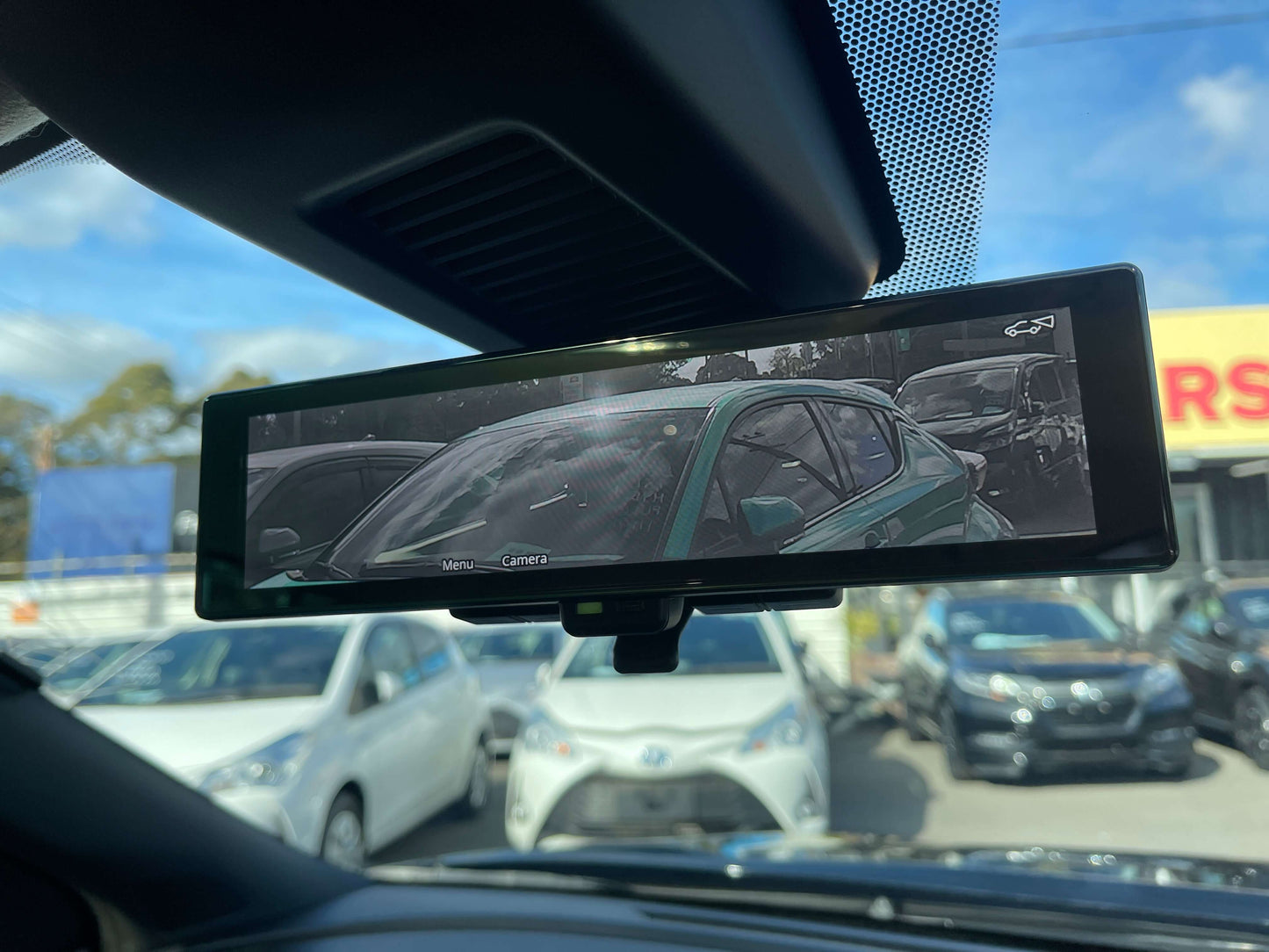 Rearview camera display showing multiple cars, highlighting safety features of the 2020 Nissan Kicks e-Power X Edition.