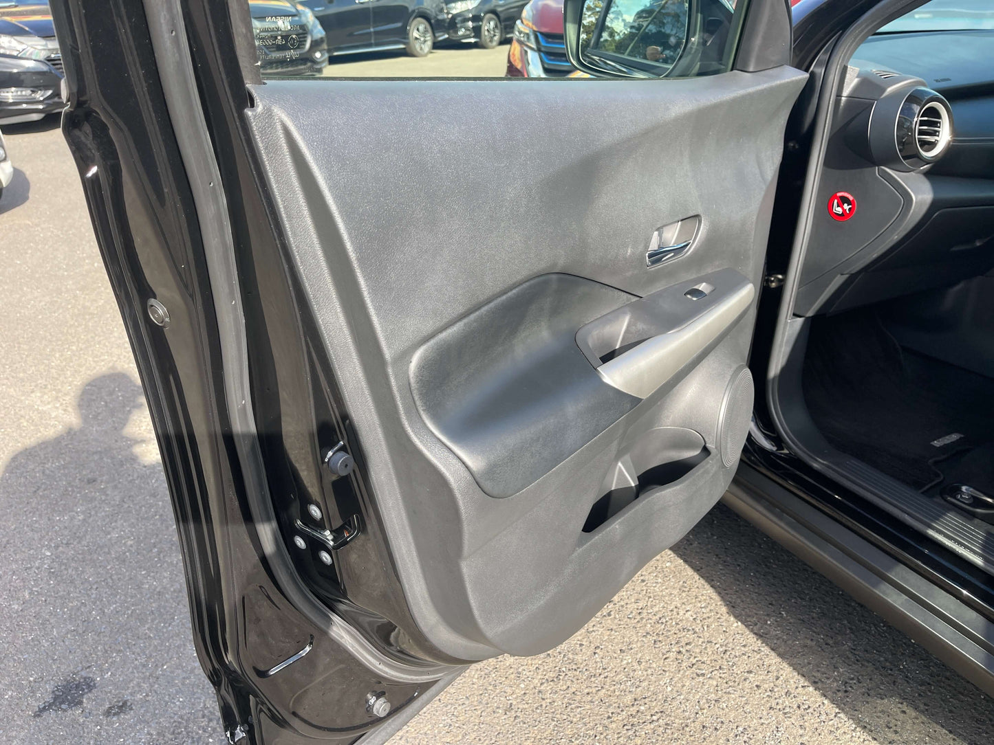 Interior door panel of a 2020 Nissan Kicks e-Power X Edition showcasing its design and features.