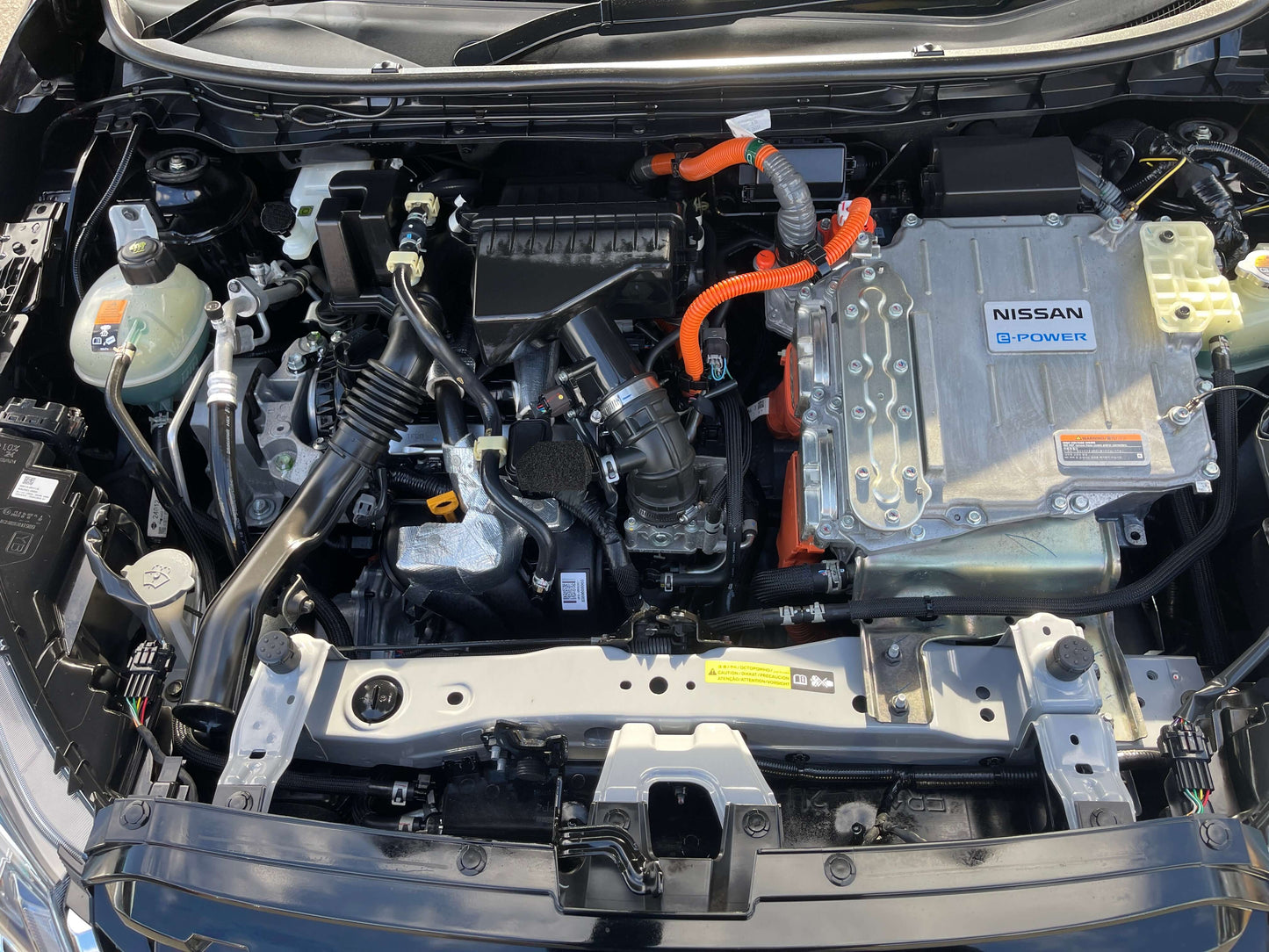 Image of the engine compartment of a 2020 Nissan Kicks e-Power X Edition showcasing hybrid components.