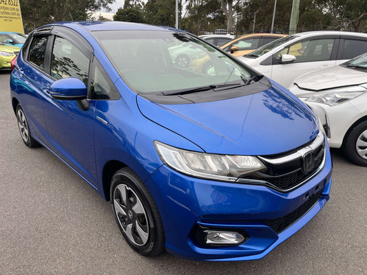 2018 Honda Fit 1.5 Hybrid L Honda Sensing in blue color, 5-seater, parked among other cars.