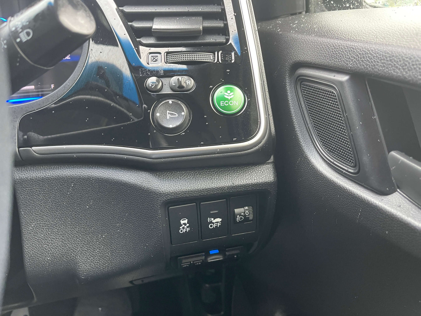 Interior controls of a 2015 Honda Grace 1.5 Hybrid showing buttons and eco mode switch.
