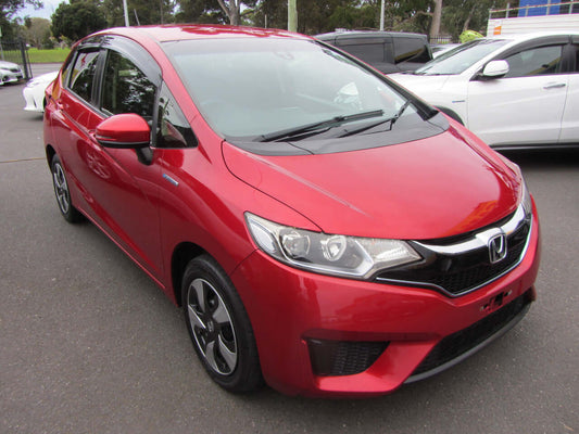2017 Honda Fit 1.5L Hybrid, red hatchback, compact 5-seater, parked with other cars.